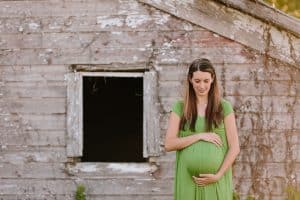 A country lifestyle maternity session right at Jen and Sean's home in Caledonia Michigan. Jen wore a beautiful green dress and their dogs even made an appearance.