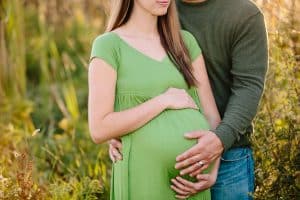 A country lifestyle maternity session right at Jen and Sean's home in Caledonia Michigan. Jen wore a beautiful green dress and their dogs even made an appearance.