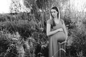 A country lifestyle maternity session right at Jen and Sean's home in Caledonia Michigan. Jen wore a beautiful green dress and their dogs even made an appearance.