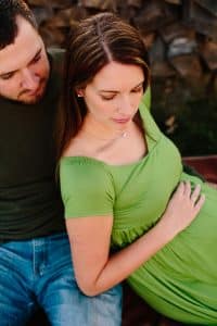 A country lifestyle maternity session right at Jen and Sean's home in Caledonia Michigan. Jen wore a beautiful green dress and their dogs even made an appearance.