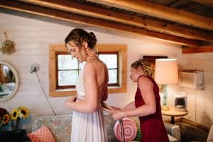 Cailly and Tyler had a rainy wedding day at Millcreek Barn in Michigan. Cailly wore a beautiful and unique wedding dress from Truvelle.