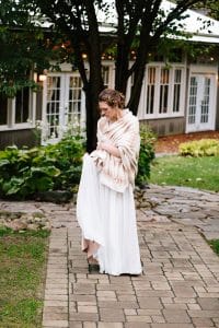 Cailly and Tyler had a rainy wedding day at Millcreek Barn in Michigan. Cailly wore a beautiful and unique wedding dress from Truvelle.