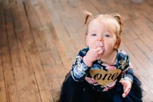 A baby girl turns one and has a cake smash during her photo shoot.