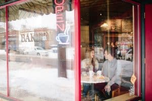 A winter engagement session in Grand Rapids, MI photographed by Mae Photo Co at Provin Trails, Aquinas college, and wealthy street bakery.