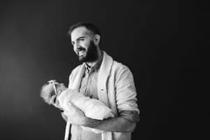 A dad with his newborn girl during an in home newborn session in Grand Rapids.