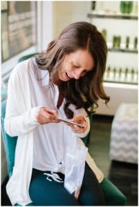 Photograph of bride reading a letter before her wedding