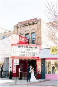 Bride and groom in front of a movie theater in downtwon grand haven