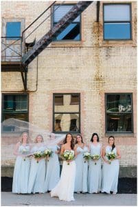 Bridal party standing in front of an old building in Grand Haven.