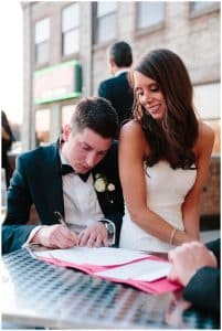 Bride and groom signing their marriage license at the Harbourfront place in Grand Haven