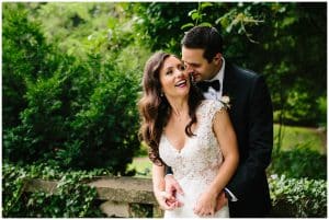The bride and groom smiling and laughing as they celebrate outside after their wedding cerremony.