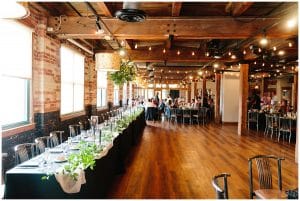 A picture of the wedding venue all decorated for the bridal party and their guests before the reception starts.