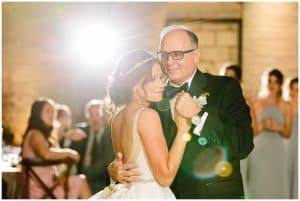 A bride dances with her father at the wedding reception.