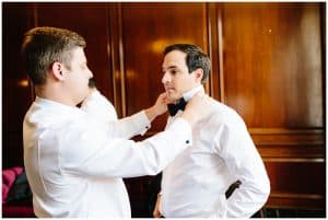 A Groom getting ready with his groomsmen before the wedding.