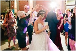 A bride dancing with her guests.