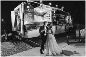 A bride and groom get tacos catered to their wedding reception near the end.