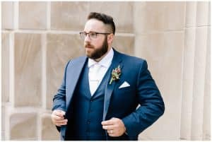 A close up shot of the groom in his suite standing outside in Grand Rapids, Michigan.