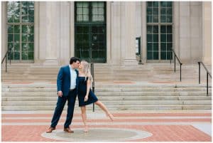 A couple leans in to kiss each other for their engagement photo session at the U of M.