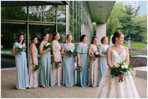 A bride with her bridesmaids looking into the distance.