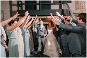 A bride and groom enter their reception in Holland, Michigan as the guests welcome them.