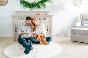 An in home newborn session in Grand Rapids in a woodland themed nursery with mom and dad and a dog.