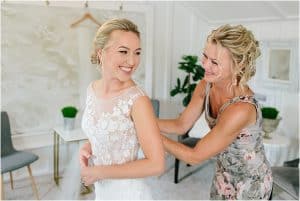 Getting ready photos on a bride's wedding day with her mom at Hydrangea Blu Barn in Rockford, Michigan.